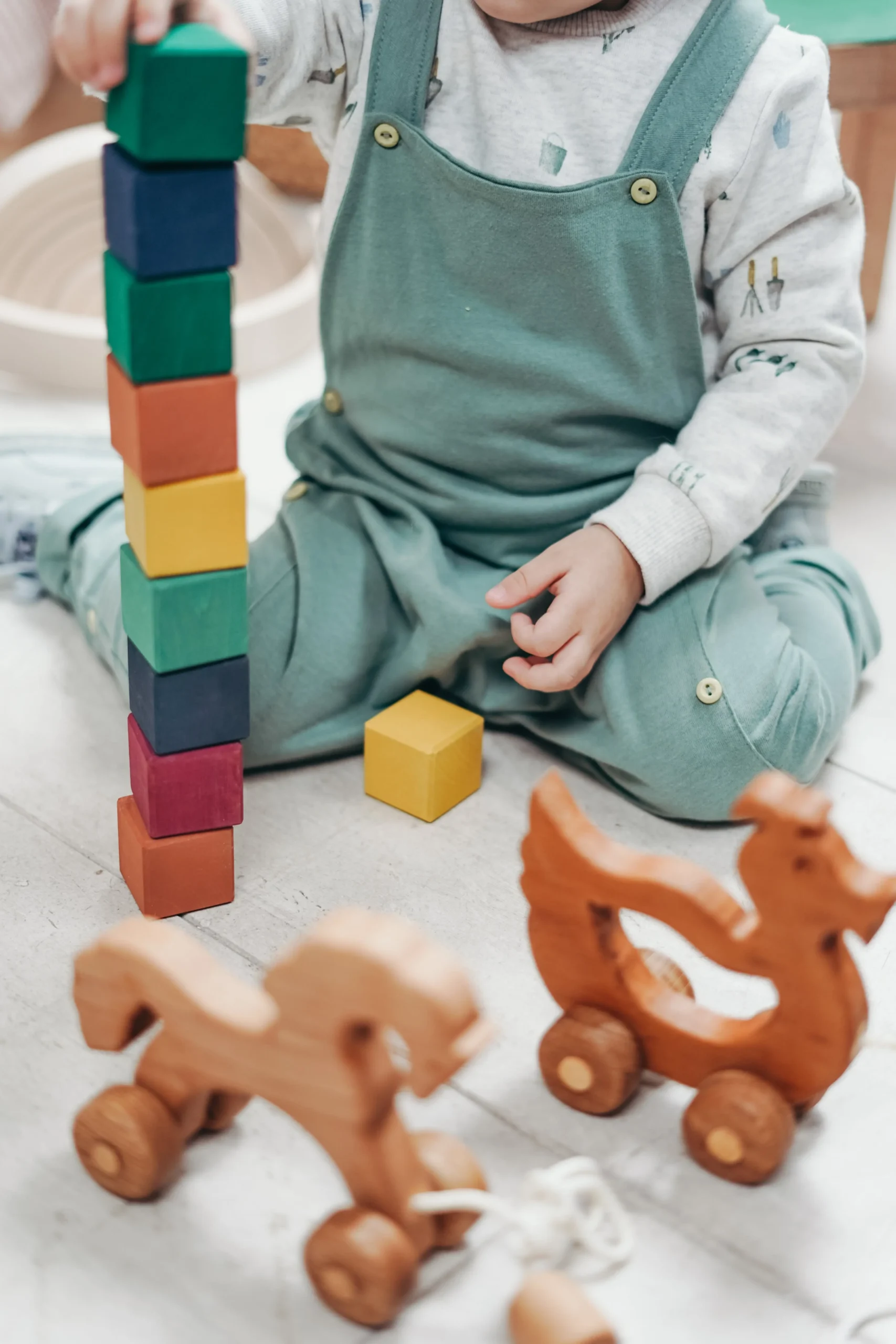 Child playing on the floor. A childcare organization is accused of misconduct.