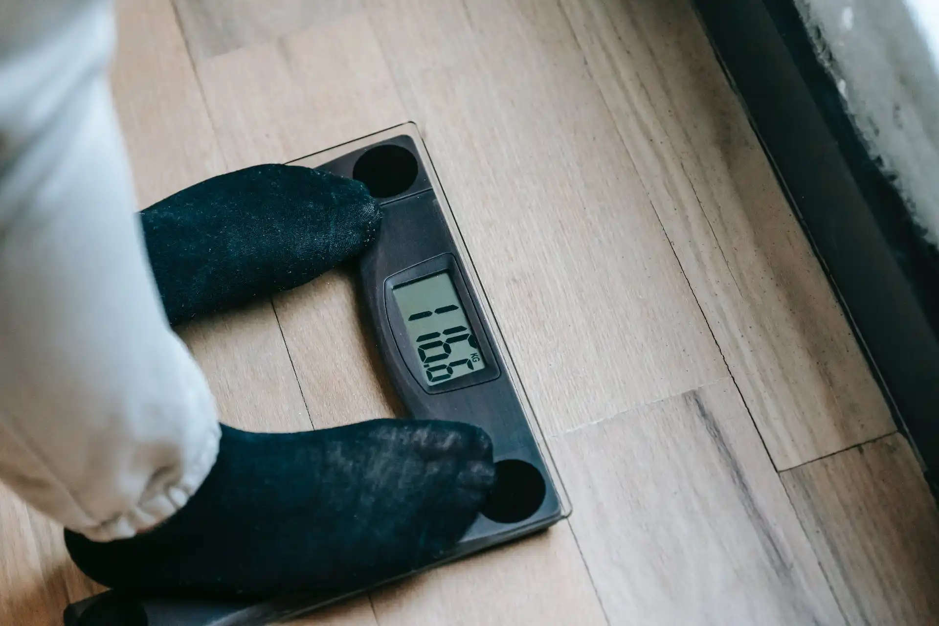 Person being weighted with scale